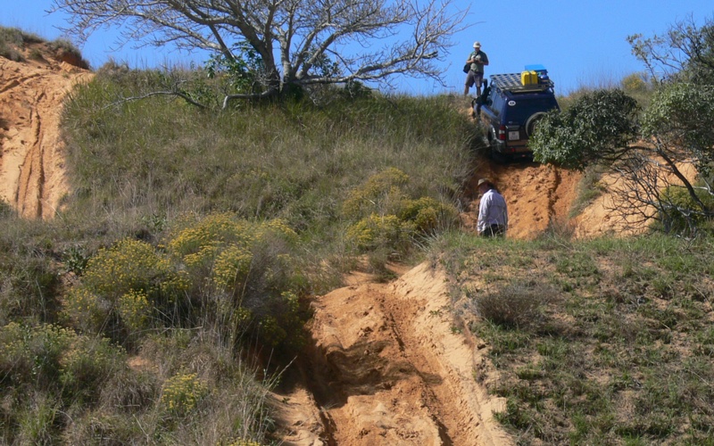 Getting to the top of a steep sandy track.