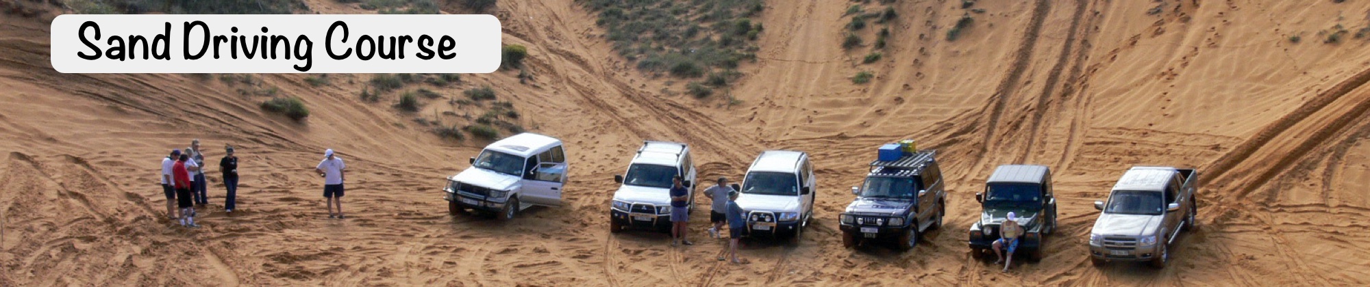 Drivers and vehicles on the sand driving course.