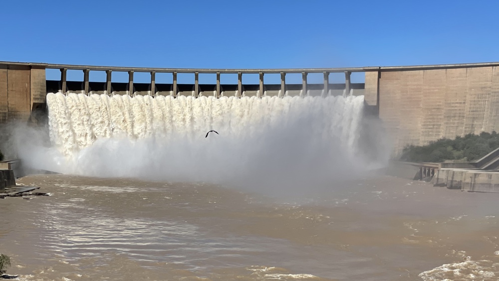 A huge amount of water flowing over the dam.